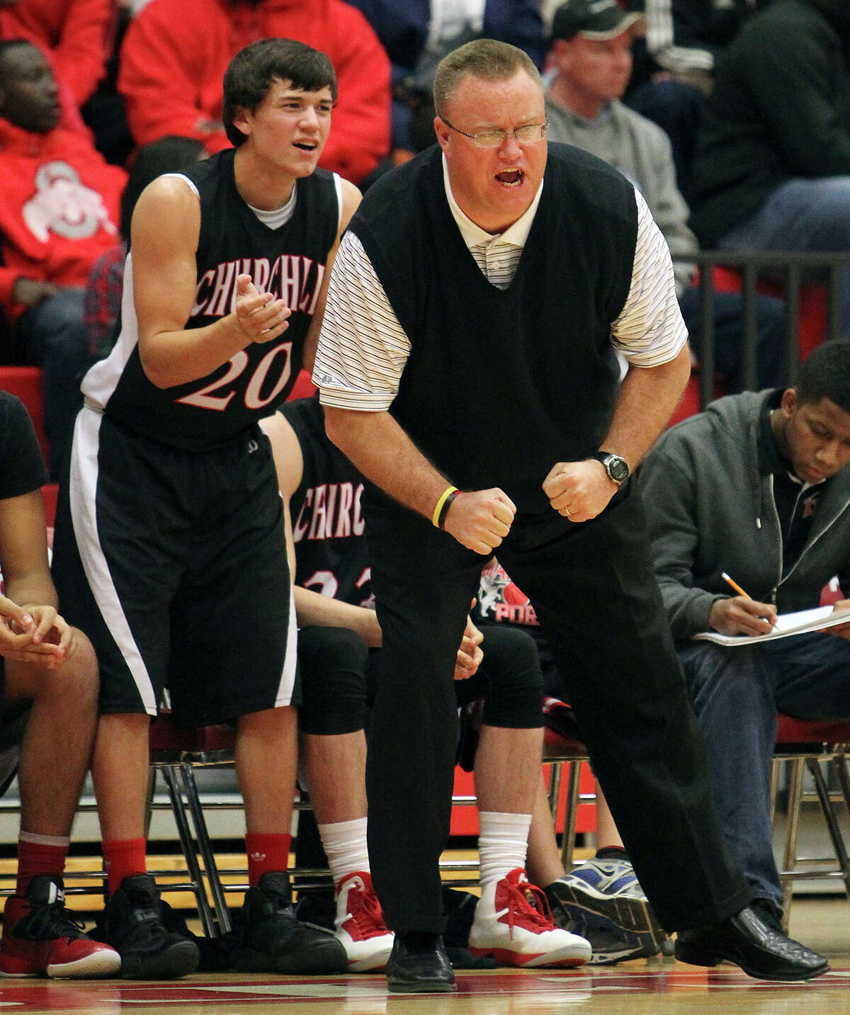 Churchill coach Timothy Woods pumps up his team during their game against Judson on Tuesday, Dec. 11, 2012. Churchill defeated Judson, 57-54.