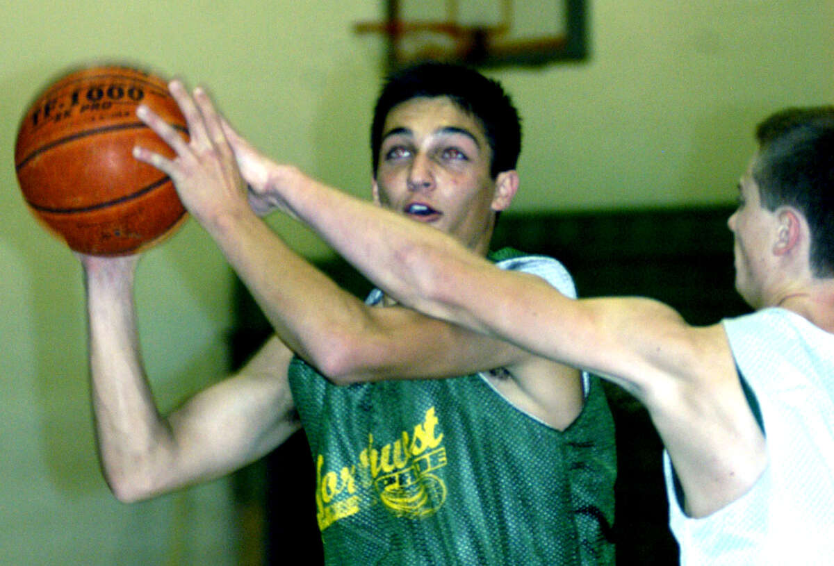 Green Wave teammate James Flynn needs to resort to a foul to slow Dylan Kartchner of New Milford High School boys' basketball during a pre-season drill, December 2012
