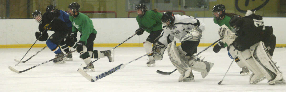 The Green Wave works on its skating skills and fitness in preparation for the New Milford High School ice hockey season. December 2012