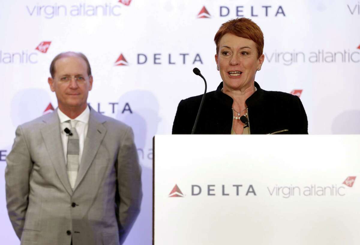 Virgin Atlantic CCO Julie Southern speaks while Delta Airlines CEO Richard Anderson listens during a news conference in New York, Tuesday, Dec. 11, 2012. Delta Air Lines said it will buy almost half of Virgin Atlantic for $360 million as it tries to catch up to rivals in the lucrative New York-to-London travel market. (AP Photo/Seth Wenig)