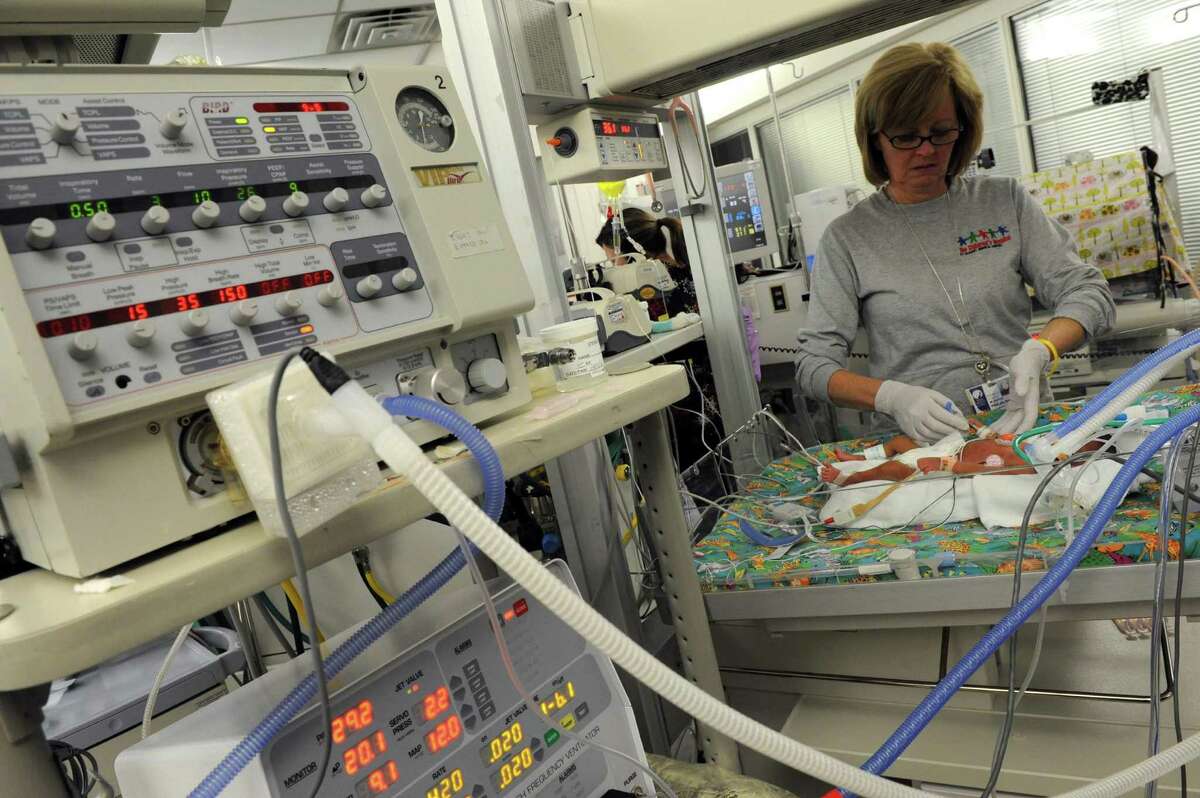 Neonatal RN Kathy Whalen attends to a new born at Albany Medical Center?s Neonatal Intensive Care Unit in Albany , NY Wednesday Dec. 12, 2012. (Michael P. Farrell/Times Union)