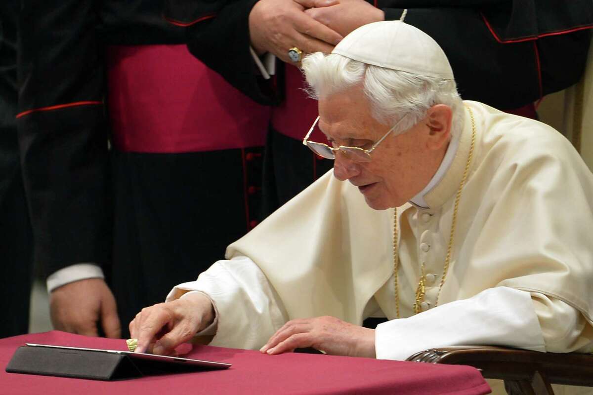 Pope Benedict XVI clicks on a tablet to send his first twitter message during his weekly general audience on Wednesday at the Paul VI hall at the Vatican.
