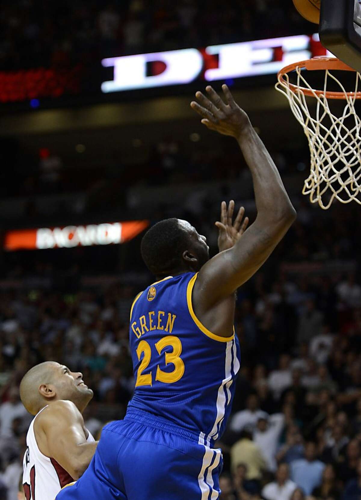 Golden State Warriors' Draymond Green (23) hits the game-winning basket against Miami Heat's Shane Battier, left, during an NBA basketball game on Wednesday, Dec. 12, 2012, in Miami. The Warriors won 97-95. (AP Photo/Rhona Wise)