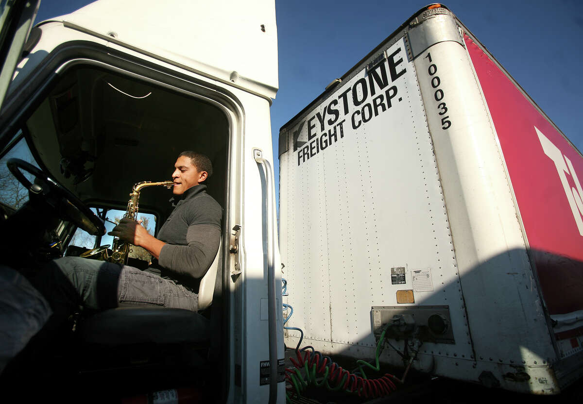 Truck driver Eli Nin of Passaic, NJ, practices his saxophone while parked in the truck parking area at the I-95 southbound rest stop in Fairfield on Thursday, December 13, 2012. Nin said that Connecticut's rest stop situation is better than others in the tri-state region surrounding New York City.