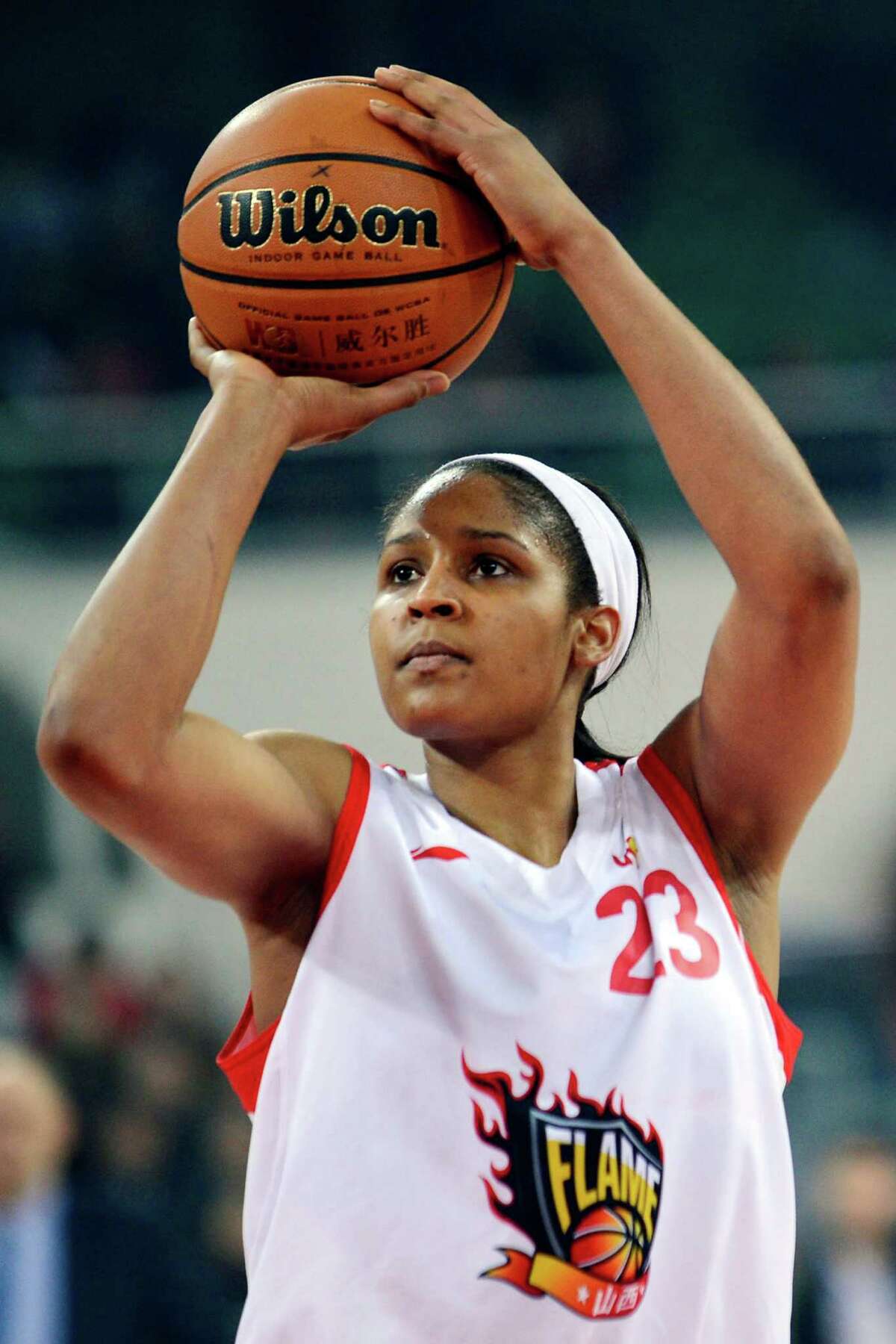 In this Nov. 24, 2012, photo, Shanxi Flame's Maya Moore shoots against the Jiangsu Dragons during a WCBA basketball game in Taiyuan, China. While her Minnesota Lynx team awaits the return of WNBA training camp in May, Moore is averaging 45 points a game and earning mid-six figures for the Flame, helping bring new fans to the women's game in a baseball crazed nation. (AP Photo/CHINATOPIX) CHINA OUT