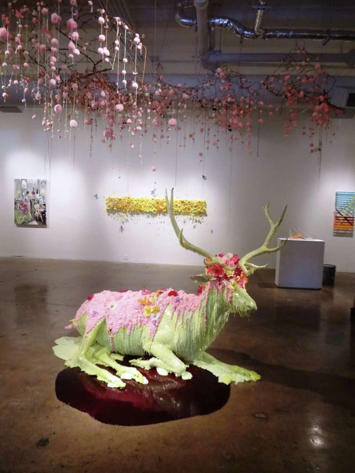 Ann Wood strives for an "attraction/repulsion" quality in large-scale sculptural installations such as "Festoon," which uses taxidermy forms, colorful foam, fake flowers and pink puff balls purchased at Hobby Lobby, the Houston artist's favorite store.