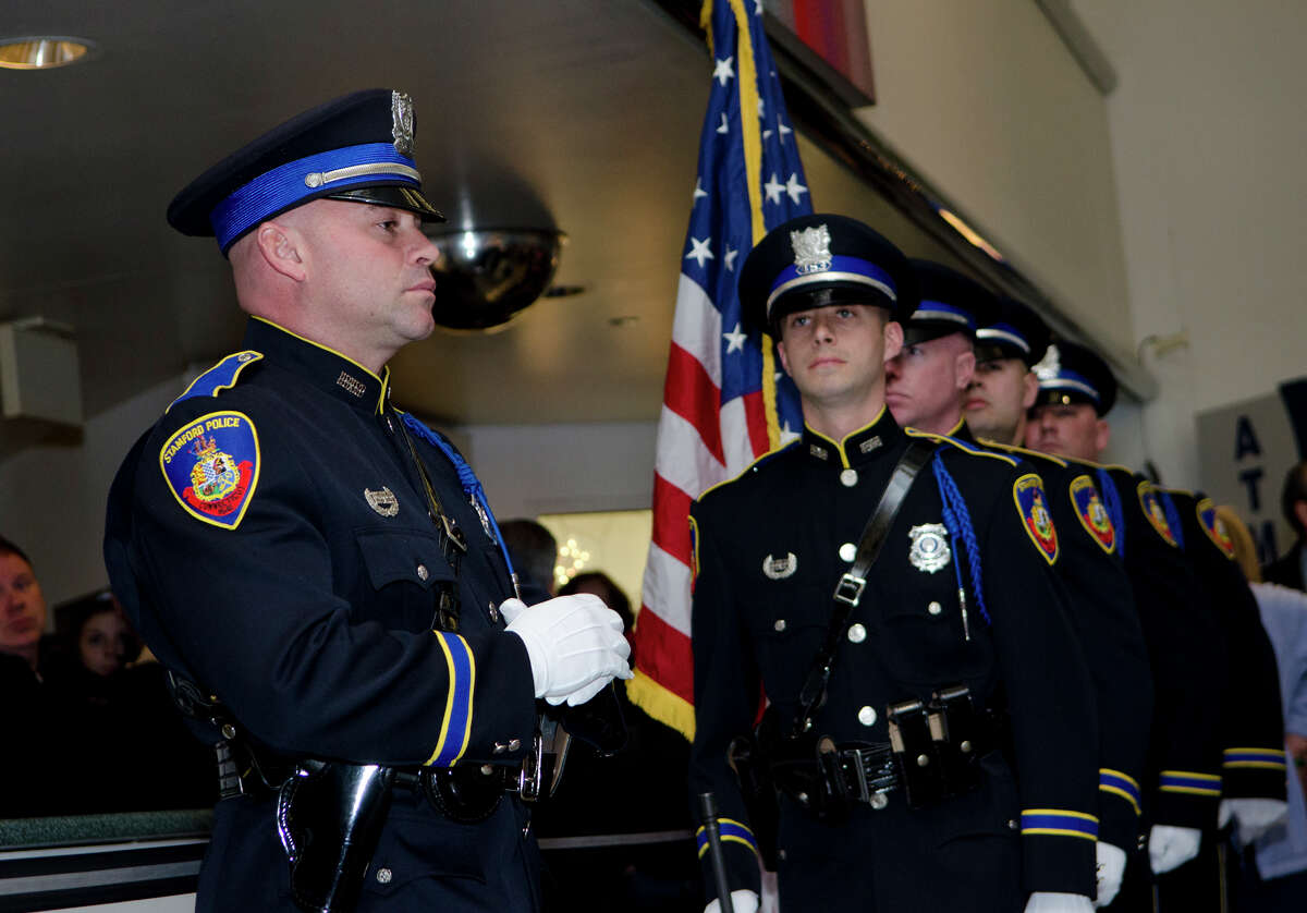 Stamford Police Honor Guard, Erin Trew, far left, stands at attention before posting the colors during the swearing in ceremony for Interim police Chief Jon Fontneau at the Stamford Government Center on Thursday, Dec. 13, 2012.