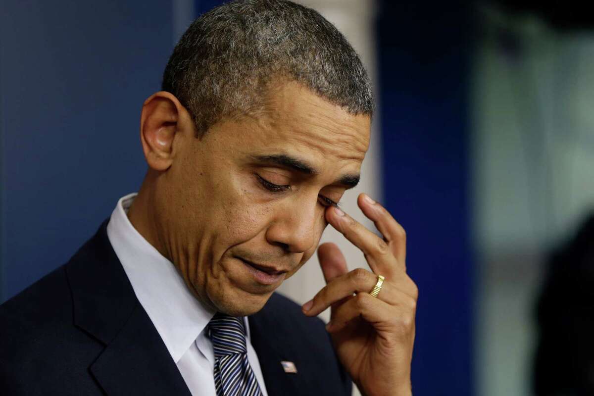 President Barack Obama wipes his eye as he speaks about the elementary school shooting in Newtown, Conn., Friday, Dec. 14, 2012, in the briefing room of the White House in Washington. (AP Photo/Charles Dharapak)