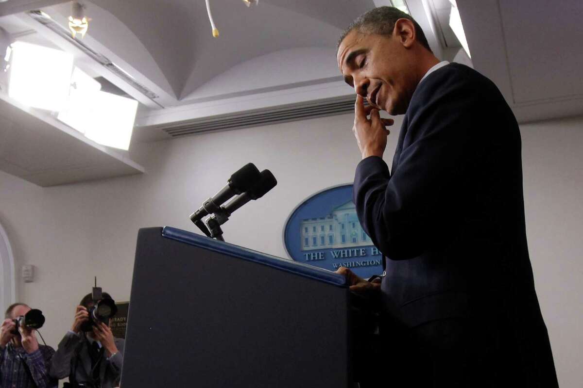 President Barack Obama wipes his eye as he speaks about the school shooting in Newtown, Conn., Friday, Dec. 14, 2012, in the briefing room of the White House in Washington. (AP Photo/Charles Dharapak)