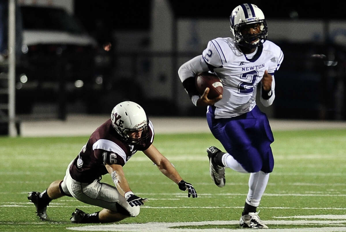 Newton quarterback Dale Dean, #2, takes a first down on a quarterback keeper during the Newton High School Class 2A Division I state semifinal game against Cameron Yoe at the Woodforest Bank Stadium in Shenandoah, TX on December, 14, 2012. Photo taken: Randy Edwards/The Enterprise