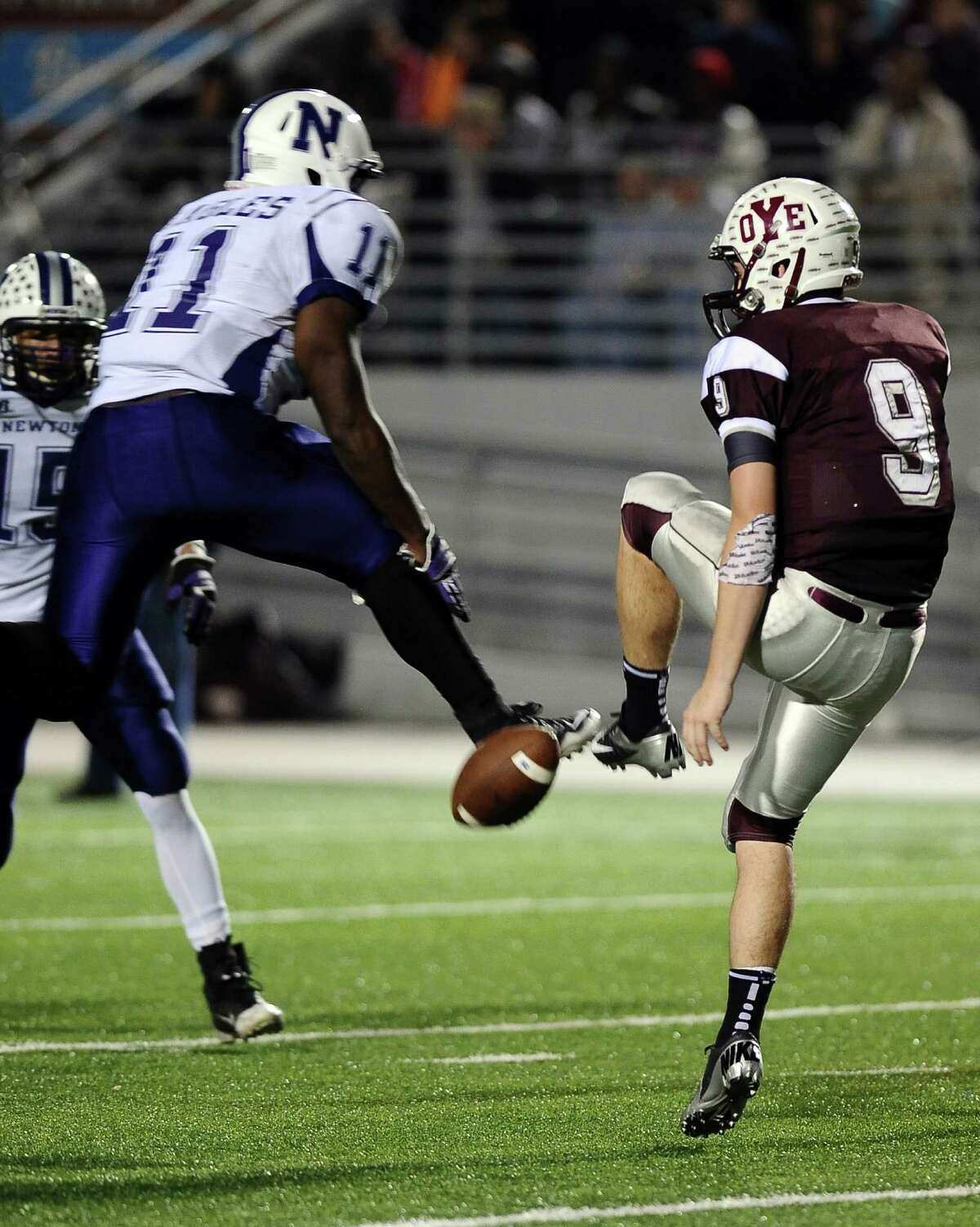 Newton running back Anthony Hadnot, #11, blocks the punt that is picked up by Romando Stewart, #15, and scored another Eagle touchdown during the Newton High School Class 2A Division I state semifinal game against Cameron Yoe at the Woodforest Bank Stadium in Shenandoah, TX on December, 14, 2012. Photo taken: Randy Edwards/The Enterprise
