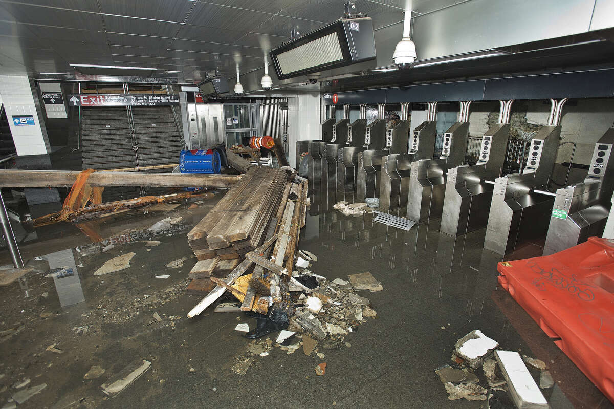 FILE - In this Oct. 30 2012 file photo provided by the Metropolitan Transportation Authority, the South Ferry subway station in New York City is filled with seawater and debris from Superstorm Sandy. Nearly 4 out of 5 Americans now think temperatures are rising and that global warming will be a serious problem for the United States if nothing is done about it, a new Associated Press-GfK poll finds. Belief and worry about climate change are inching up among Americans in general, but concern is growing faster among people who don't often trust scientists on the environment. In follow-up interviews, some of those doubters said they believe their own eyes as they've watched thermometers rise, New York City subway tunnels flood, polar ice melt and Midwestern farm fields dry up. (AP Photo/ Metropolitan Transportation Authority, File)