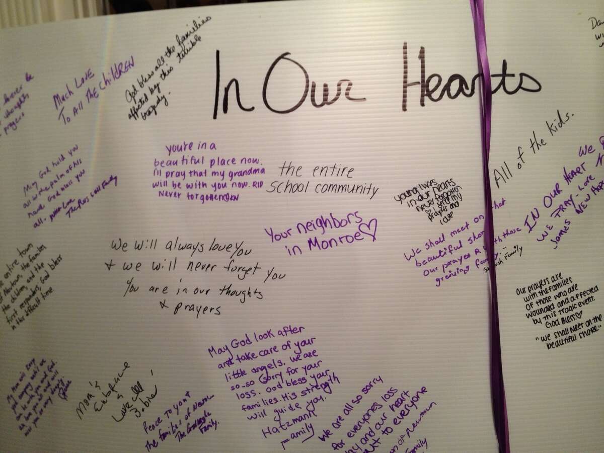 A condolence card is filled with writings at a ceremony for victims of the Newtown, Conn., massacre. (Paul Grondahl / Times Union)