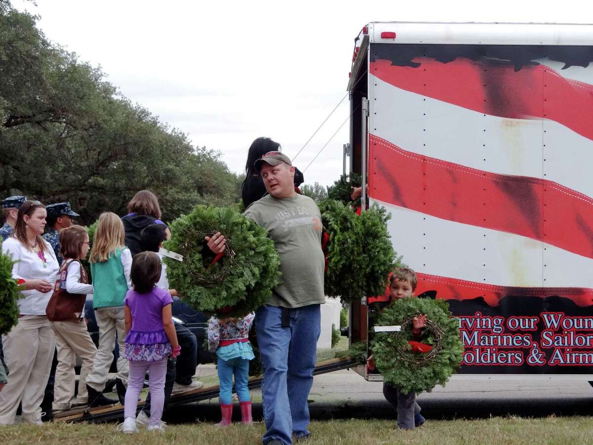 Volunteers collect wreaths to be placed on headstones of about 10,000 of the over 100,000 headstones at Fort Sam Houston National Cemetery during the Wreaths Across America event on Saturday, Dec. 15, 2012.