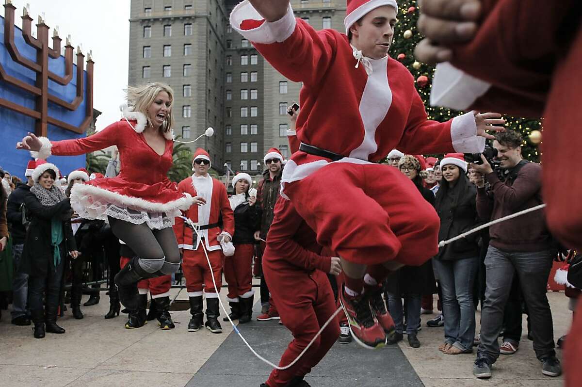 Patrick Lynch, (right) and fellow Santas skips rope in their costumes as the annual Santacon event kicks off at Union Square and then turns to pub crawls around the city on Saturday Dec. 15, 2012 in San Francisco, Calif.