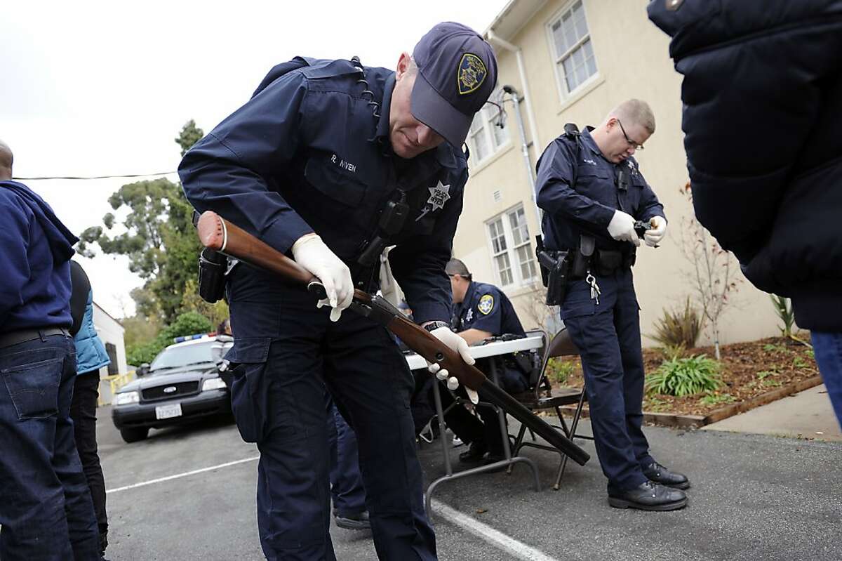 Office Niven(L) and Officer Smoak check guns for serial numbers that are then entered into OPD's database. The Oakland Police Department offered an anonymous gun buy back to the community at St. Benedict's Church in Oakland, CA Saturday December 115th, 2012.