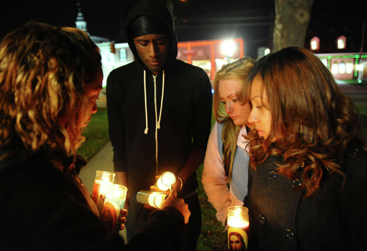 Hundreds attend a candlelight vigil in memory of victims from yesterday's mass shooting in Newtown, which was held behind Stratford High School on the Town Hall Green in Stratford, Conn. on Saturday December 15, 2012.