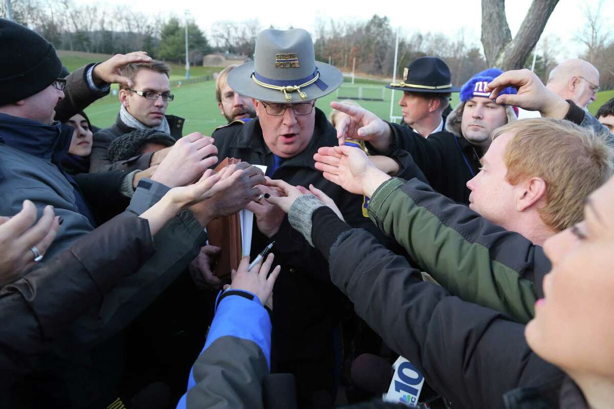 Lt. J. Paul Vance of the Connecticut State Police is surrounded by reporters as he hands out the list of victims of the shooting at the Sandy Hook Elementary School, Saturday, Dec. 15, 2012 in Sandy Hook village of Newtown, Conn.