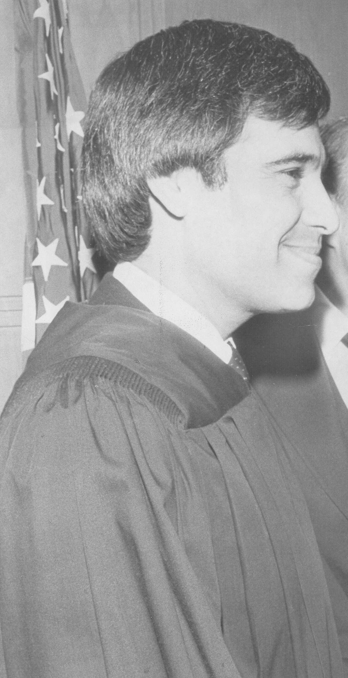 Attorney Charlie Gonzalez is sworn in as the new judge of Bexar County Court-of-Law No. 2 on Jan. 2, 1983. U.S. Rep. Henry B. Gonzalez made a few remarks to the crowd at St. Mary's University Law School before his son took the oath of office from Texas Supreme Court Justice Franklin Spears.
