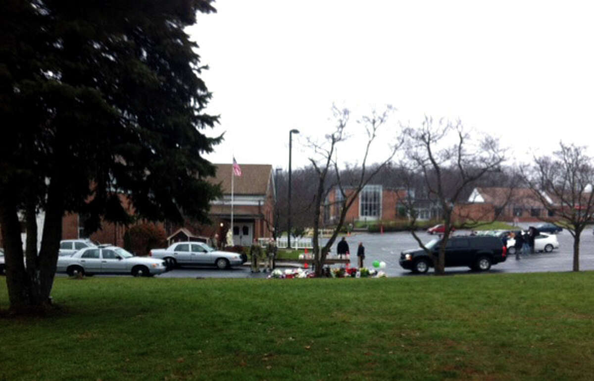 Parishioners at St. Rose of Lima Church in the Sandy Hook section of Newtown, Conn. was evacuated during mass because of an unspecified threat on Sunday, Dec. 16, 2012. Local and state police, including heavily armed officers were at the scene.