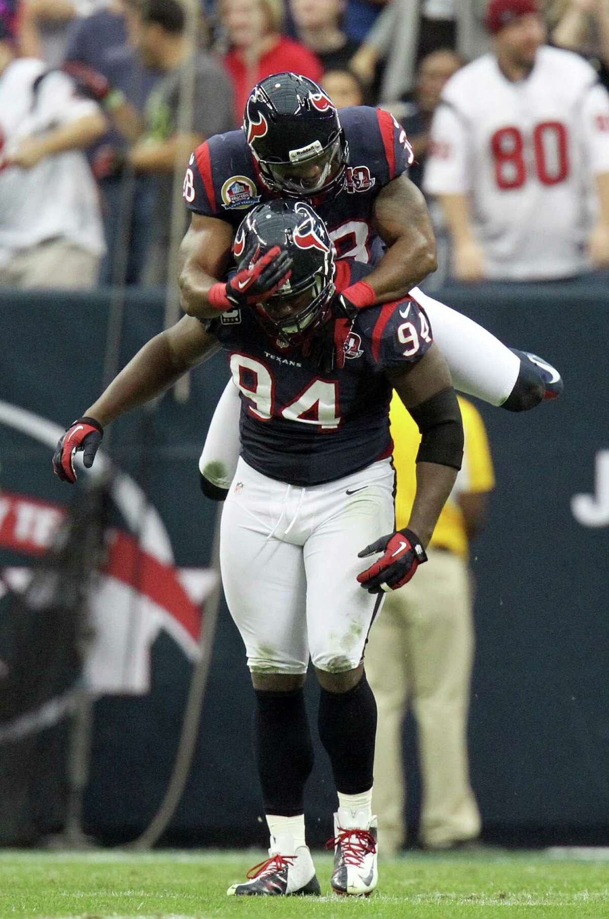 Houston Texans free safety Danieal Manning (38) jumps up on Houston Texans defensive end Antonio Smith (94) after his sack during the first quarter of an NFL football game at Reliant Stadium, Sunday, Dec. 16, 2012, in Houston.