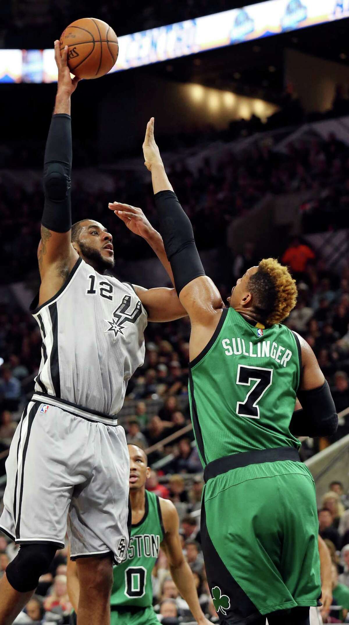 San Antonio Spurs' LaMarcus Aldridge shoots over Boston Celtics' Jared Sullinger during first half action Saturday Dec. 5, 2015 at the AT&T Center.