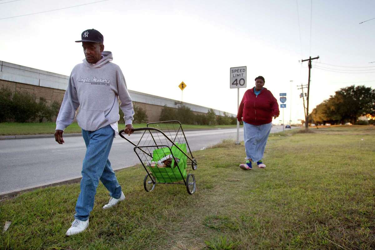 Earnest and Mary Cager walk away from the Houston Food Bank, with their groceries from the emergency pantry, on their way to a bus stop Thursday, Dec. 13, 2012, in Houston. Officials at the Houston Food Bank are trying to convince METRO to move a bus stop closer to their facilities, so that clients do not have to walk a long distance, with multiple pounds of food in hand. ( Brett Coomer / Houston Chronicle )