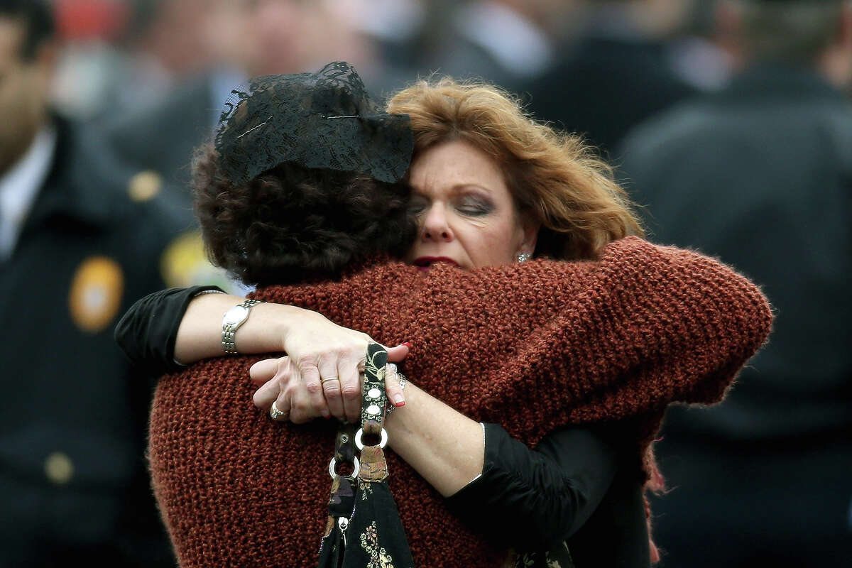 FAIRFIELD, CT - DECEMBER 17: Veronika Pozner (L) is hugged as she leaves the funeral services for her six year-old son Noah Pozner, who was killed in the shooting massacre in Newtown, CT, at Abraham L. Green and Son Funeral Home on December 17, 2012 in Fairfield, Connecticut. Today is the first day of funerals for some of the twenty children and seven adults who were killed by 20-year-old Adam Lanza on December 14, 2012.