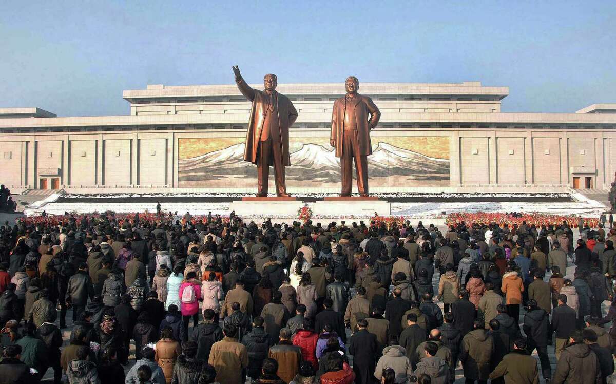 Crowds of people visit the Mansu Hill in Pyongyang before statues of late President Kim Il-Sung and leader Kim Jong-Il on the first anniversary of leader Kim Jong-Il's death on Friday.