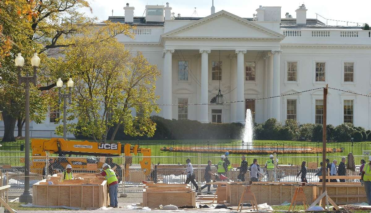 Workers are seen infront of the White House during preparation of a review stand for the presidential inauguration on November 12, 2012 in Washington,DC. The Presidential Inauguration will take place on January 21, 2013.
