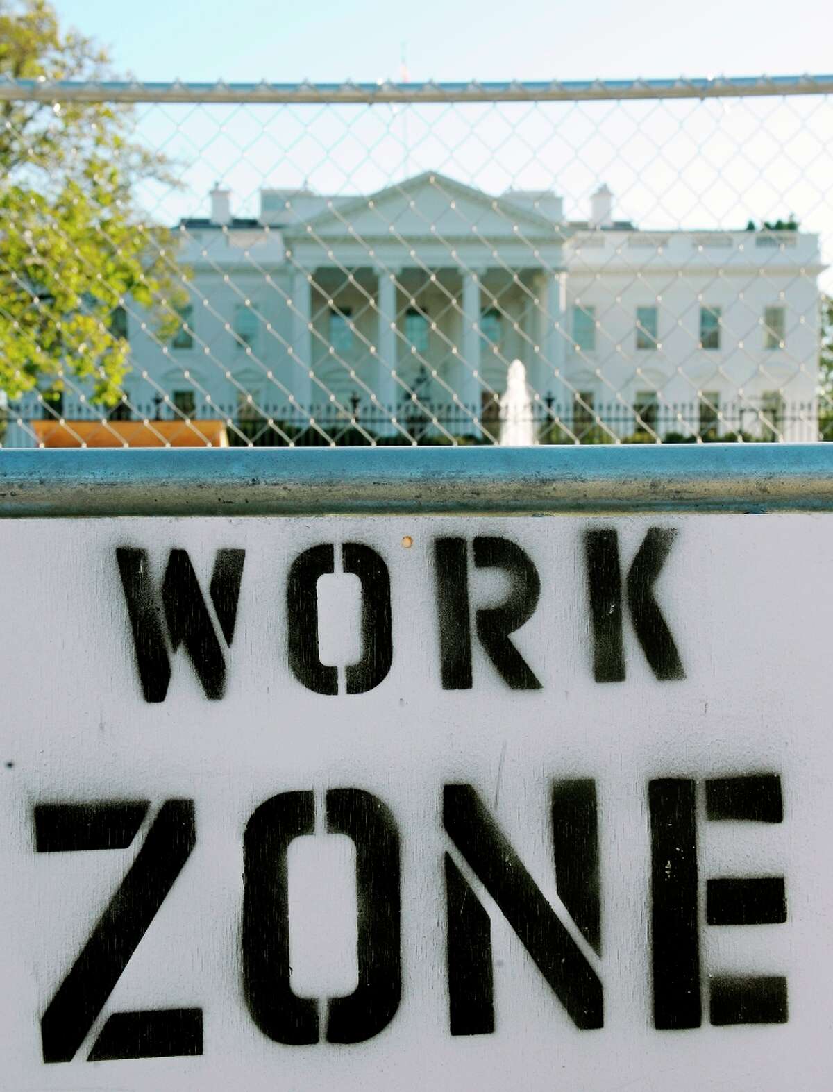 A sign on the security fence surrounding the construction area where workers are building the Presidential Inauguration reviewing stand in front of the White House in Washington, Thursday, Nov. 8, 2012. (Cliff Owen / AP Photo)