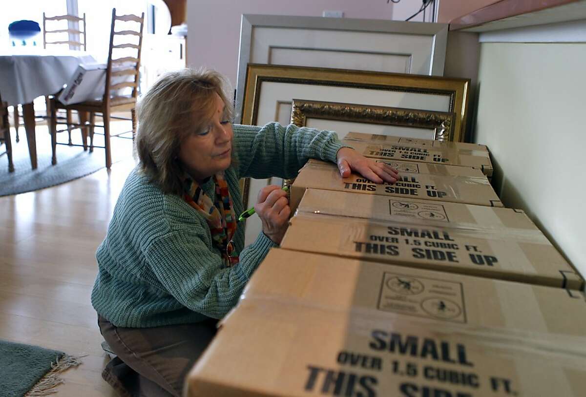 Shirley Ann Stern labels boxes before moving from her condo in San Francisco, Calif. on Friday, Dec. 14, 2012. Stern just purchased a new home near the UCSF Mission Bay campus. Congress may curtail the mortgage-interest tax deduction which, she says, would make life a lot harder financially.