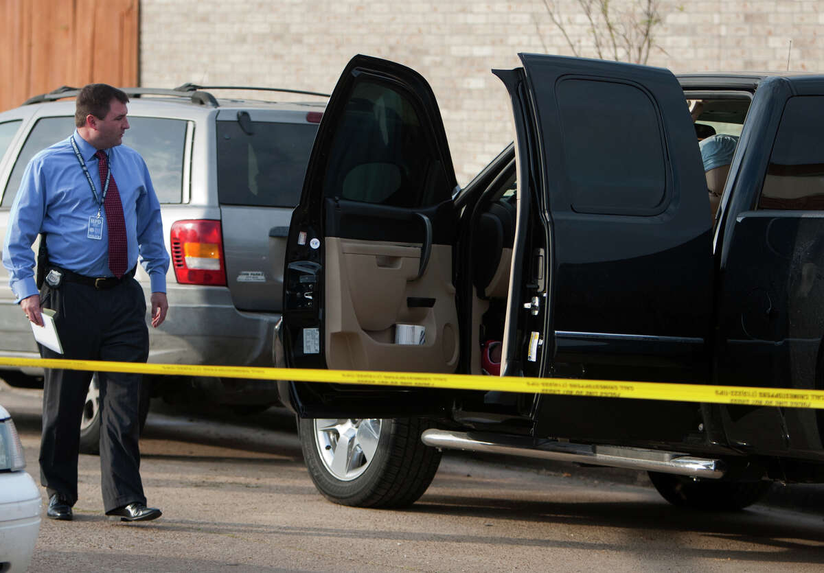 Police investigate a scene after a man was found dead in his truck on Lost Forest Drive near Pinemont Drive, Wednesday, Dec. 19, 2012, in Houston.