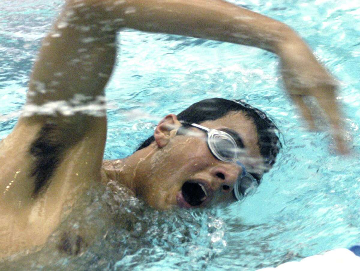 Jonathan Rajagopalan of the New Milford High School boys' swim team works himself into competitive shape during pre-season drills at the Canterbury School pool. December 2012