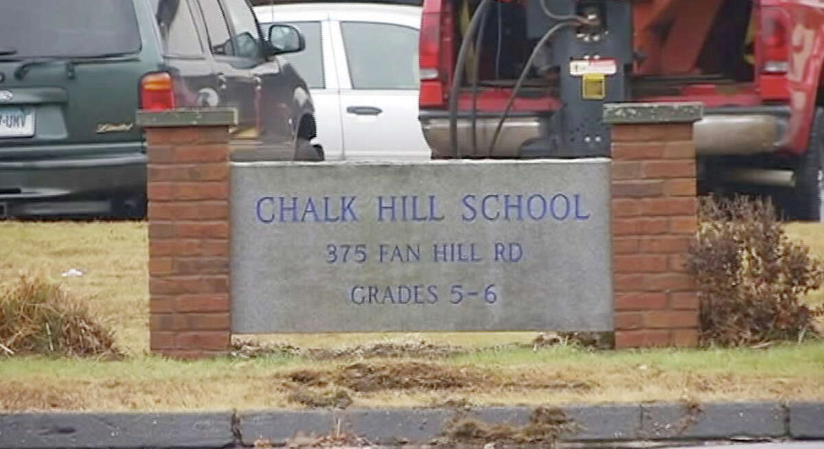 Workers setup Chalk Hill Middle School in Monroe, Conn. for use by Sandy Hook Elementary School students.
