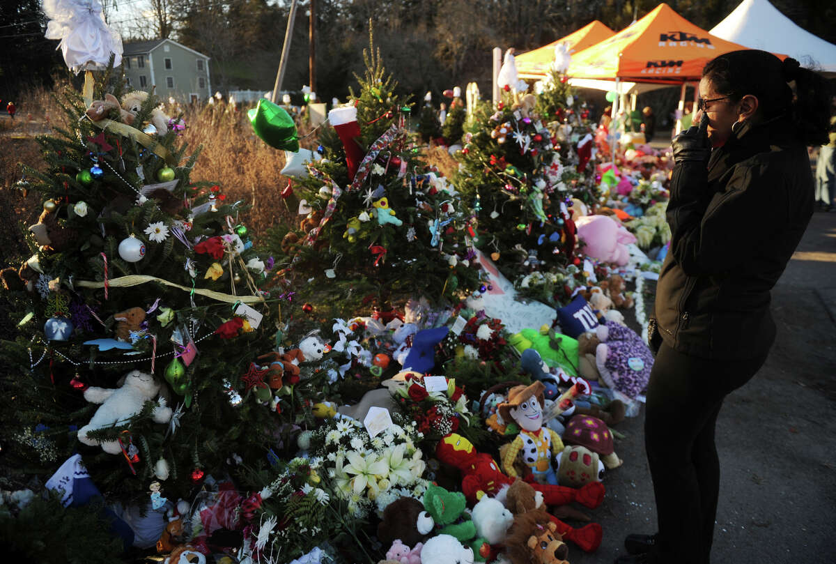 The victims memorial by the entrance to Sandy Hook Elementary School on continues to swell in size as mourners drop off remembrances on Wednesday, December 19, 2012.