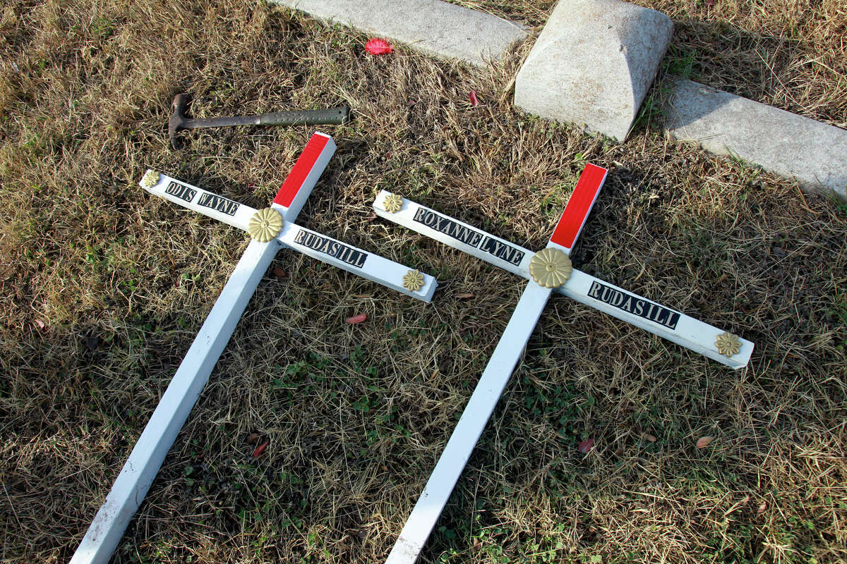 Temporary grave markers rest as the graves of two children, Roxanne Lynn Rudasill and Odis Wayne Rudasill are located in the Lytle Community Cemetery using a ground penetrating radar system employed by Glenn Zebrowski on December 19, 2012.