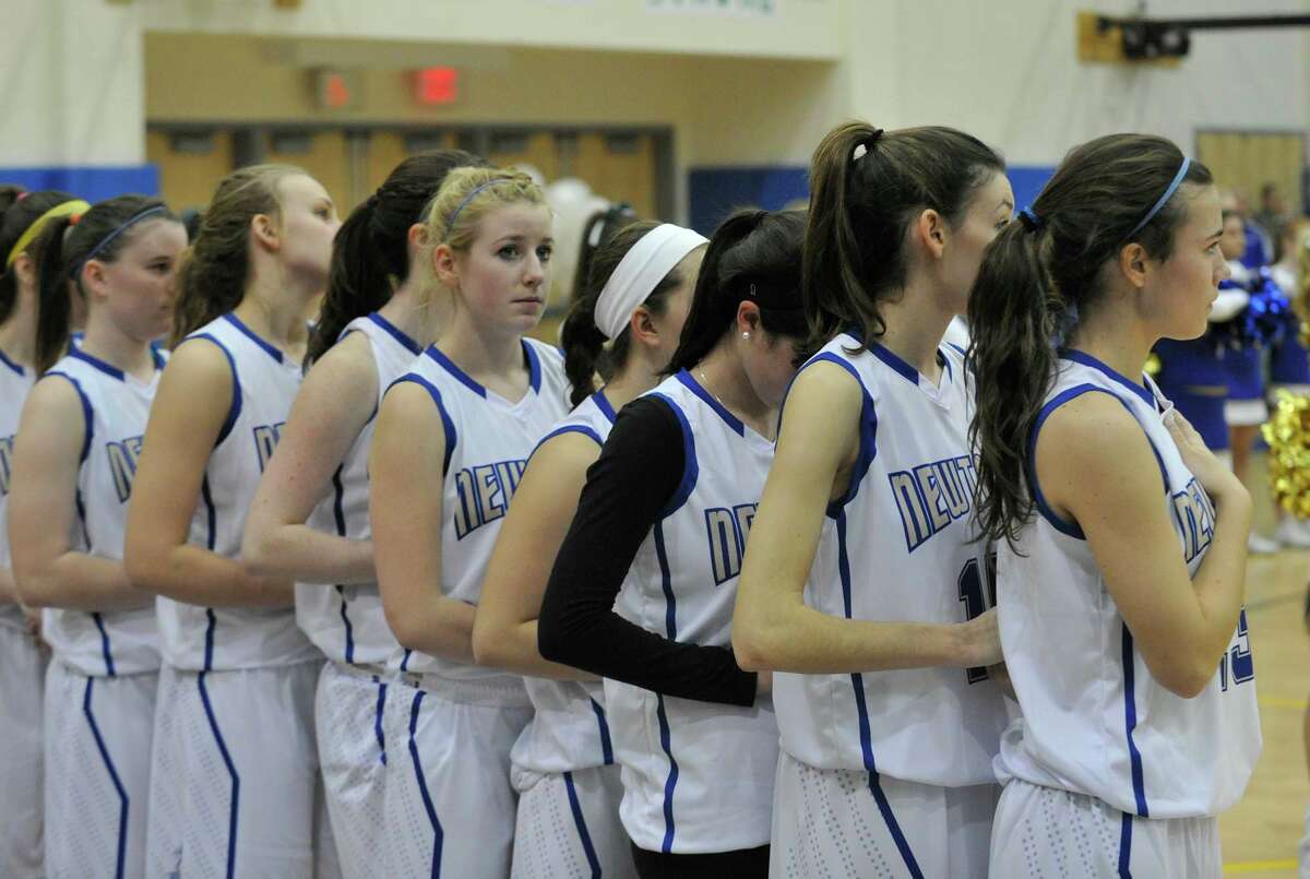 The Newtown girls basketball team takes a moment of silence during the pre-game ceremony of Nighthawk's game against Masuk on Wednesday, Dec. 19, 2012. Wednesday's basketball game was the first sporting event since the Sandy Hook Elementary School shooting.