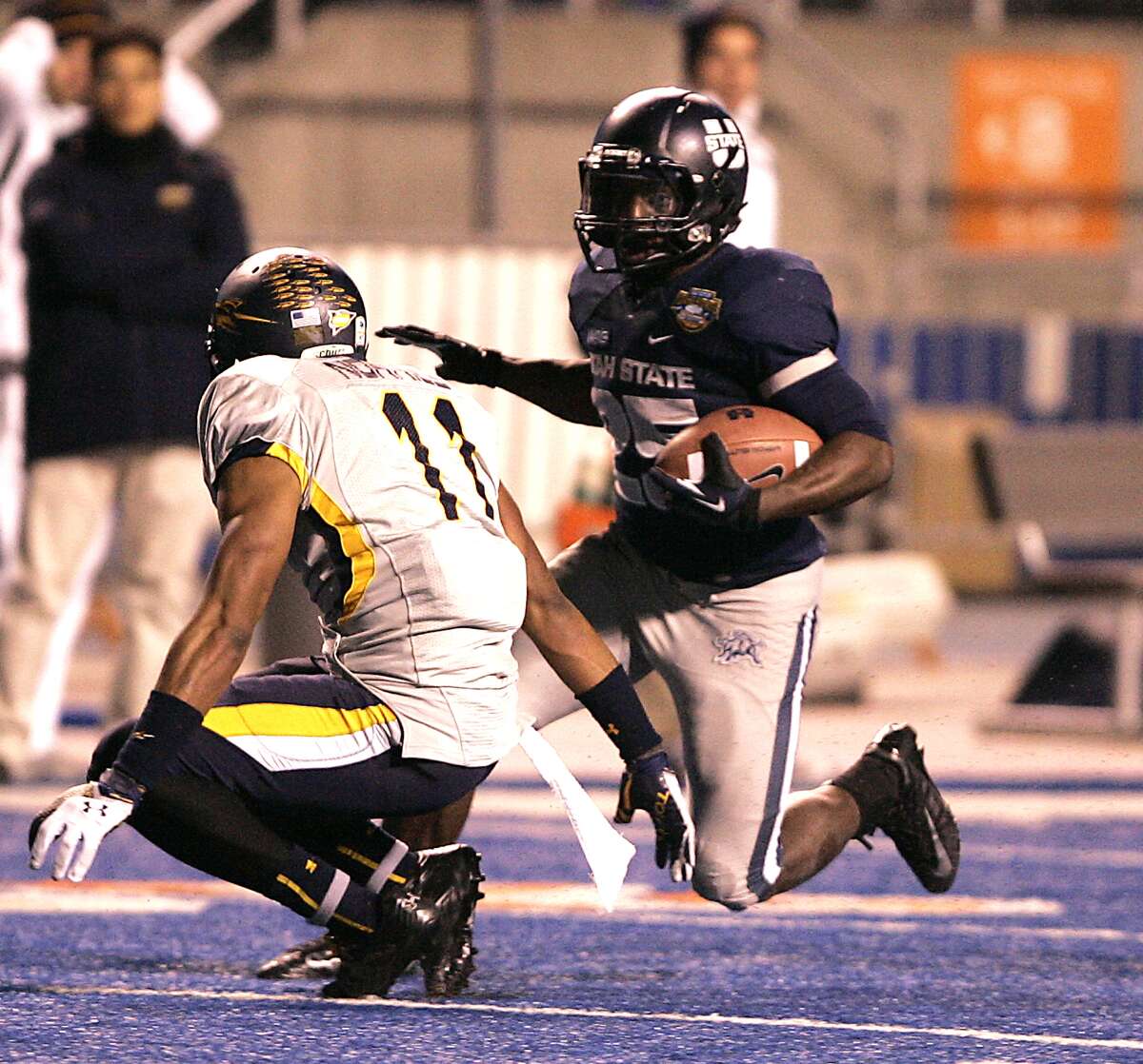 Famous Idaho Potato Bowl, Dec. 15: Utah State 41, Toledo 15; Bronco Stadium in Boise, Idaho; Payout: $325,000 PHOTO: Utah State's Kerwynn Williams (25) rushes for a first down against Toledo's Cheatham Norrils (11) during the second half of the Famous Idaho Potato Bowl.