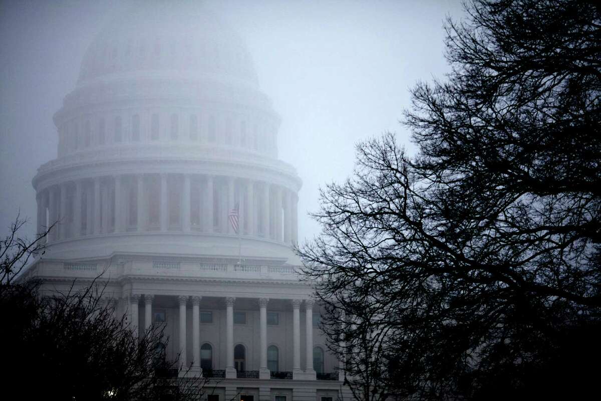 FILE - In this Dec. 10, 2012 file photo, fog obscures the Capitol dome on Capitol Hill in Washington. Big tax increases will hit millions of families and businesses a lot sooner than many realize if Congress and the White House don't agree on a plan to avoid the year-end fiscal cliff of automatic tax increases and government spending cuts. In fact, they already have. More than 70 tax breaks enjoyed by individuals and businesses already expired at the beginning of this year. If Congress doesn't extend them, a typical middle class family could get a $4,000 tax hike when they file their 2012 returns next spring, according to a private analysis. At the same time, businesses could lose dozens of tax breaks they have enjoyed for years. (AP Photo/J. Scott Applewhite)