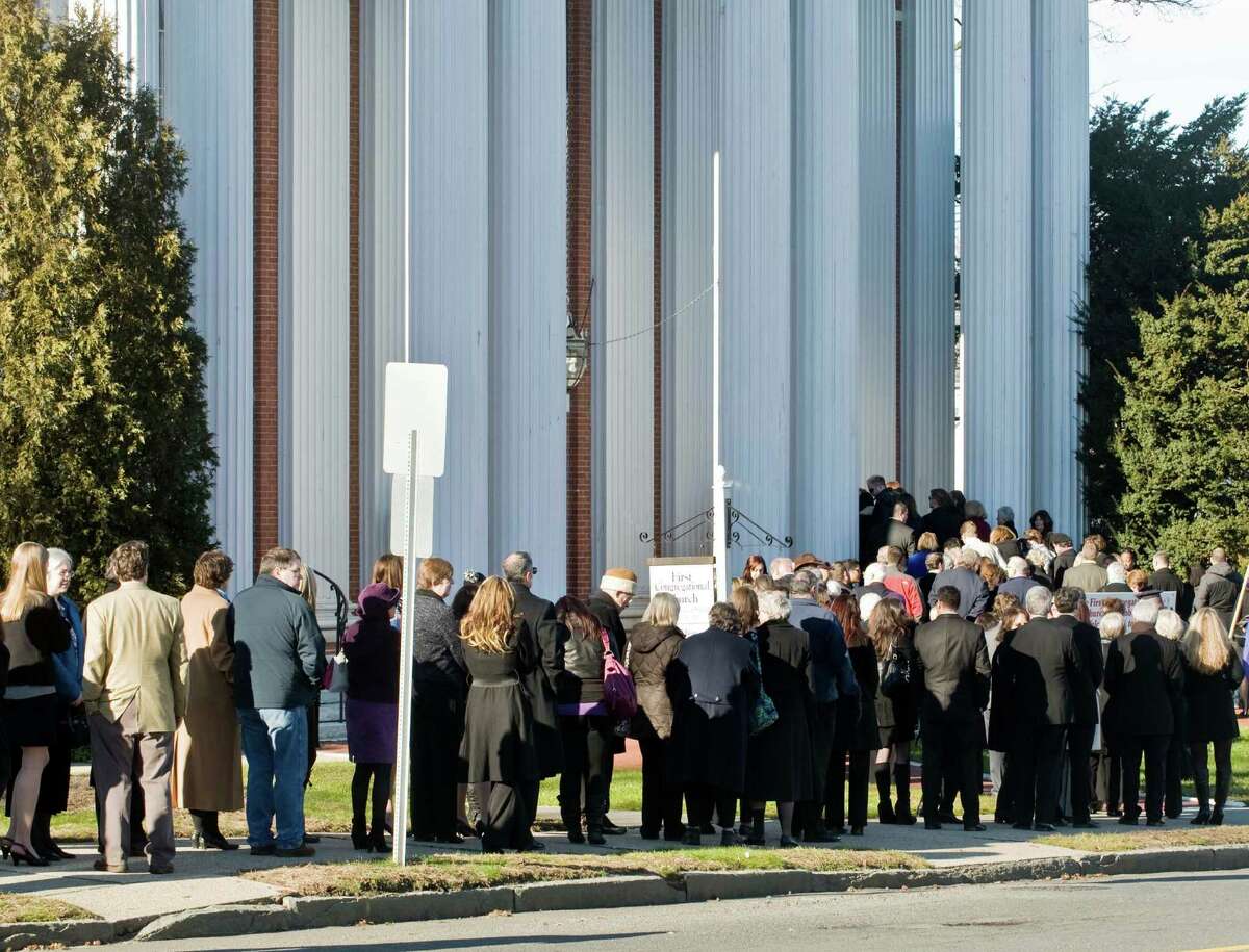 Family and friends line the sidewalk as they enter the First Congregational Church on Deer Hill Avenue in Danbury for the memorial service of Sandy Hook Elementary School teacher Lauren Rousseau. Thursday, Dec. 20, 2012
