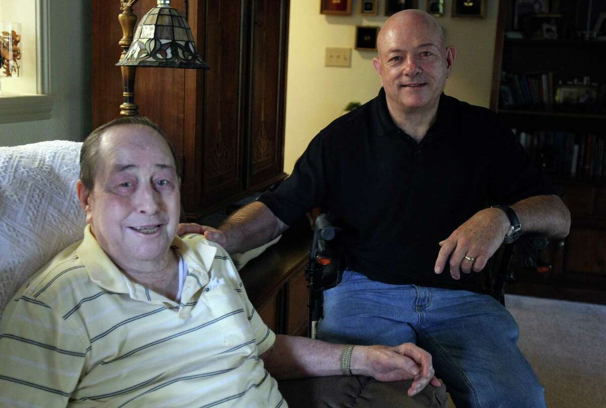 Retired Army Col. Johnny Walker, right, cares for his dad, John Walker.