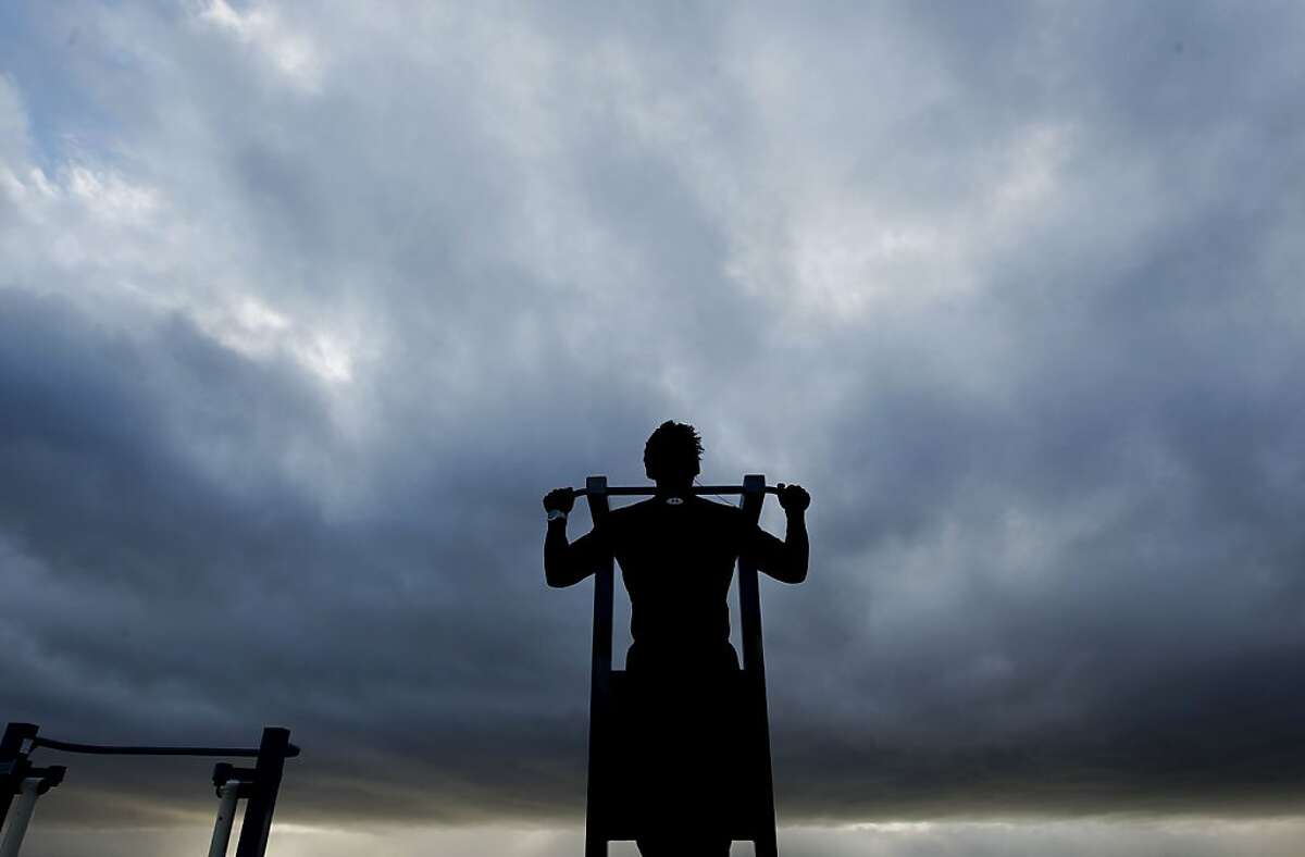 A Pastor and a physical trainer Joseph Keppard works out before the next rain rolls in across the Bay at the San Leandro Marina, as a series of storms are lined up off the coast on Friday Dec. 21,2012.