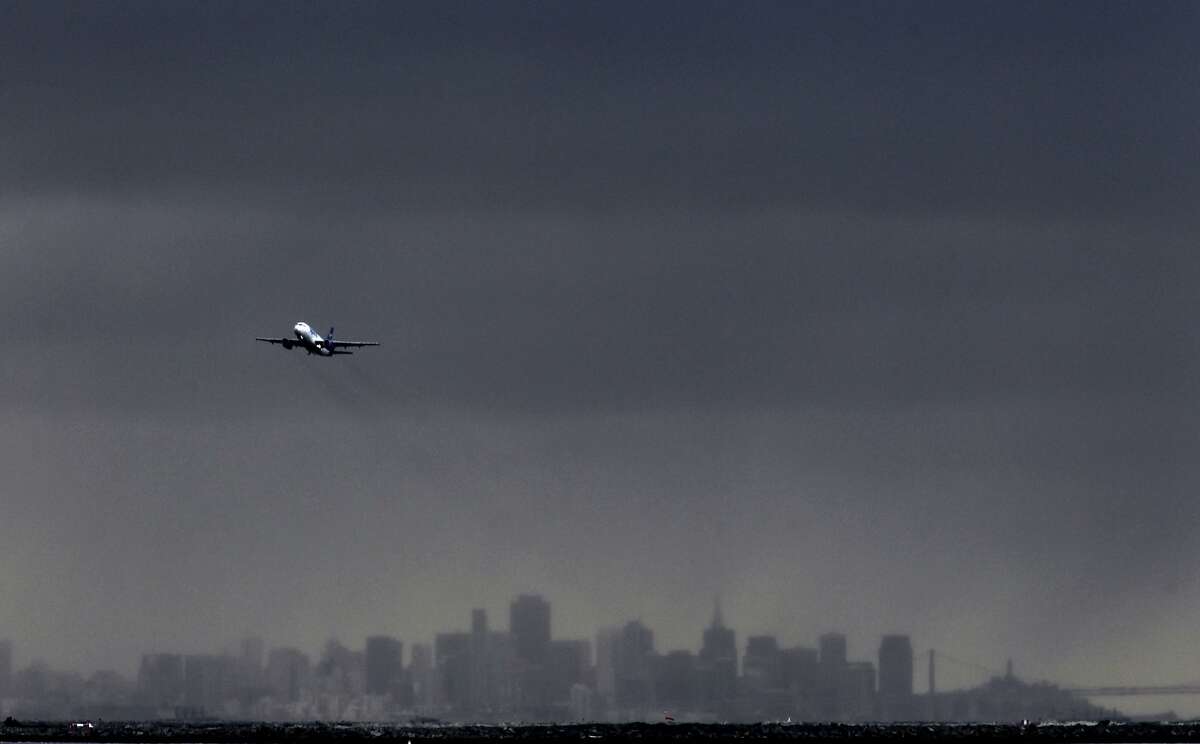 Planes take off from Oakland International Airport as a series of rain storms are lined up and on their way on Friday Dec. 21,2012.