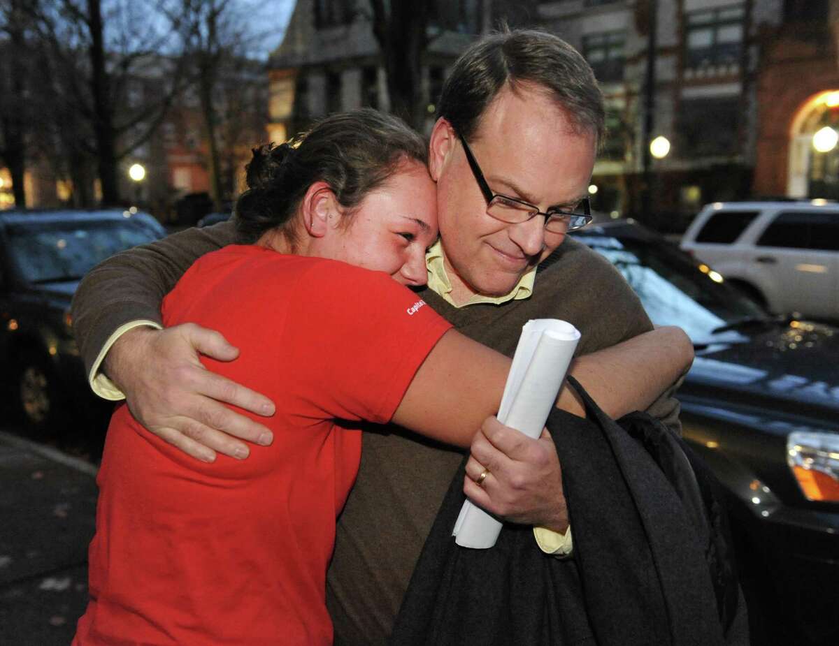 Ed McDonough gets a hug from daughter Rachael McDonough, 18, outside Rensselaer County Court after being found not guilty in his ballot fraud case Friday Dec. 21, 2012. (John Carl D'Annibale / Times Union)