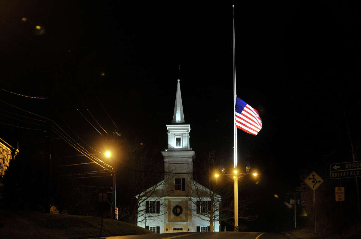 The flag pole on Main Street in Newtown flies at half-mast on Friday, Dec. 21, 2012, one week after the Sandy Hook Elementary School shooting.