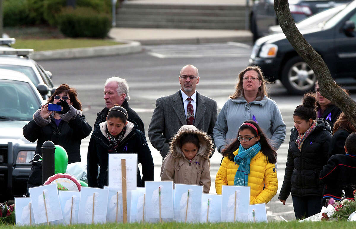 Mourners look at a memorial before the funeral for Josephine Gay at St. Rose of Lima Roman Catholic Church, Saturday, Dec. 22, 2012, in Newtown. Gay was one of 26 killed after gunman Adam Lanza opened fire killing 26 individuals, 20 whom were children, at Sandy Hook Elementary School last Friday.