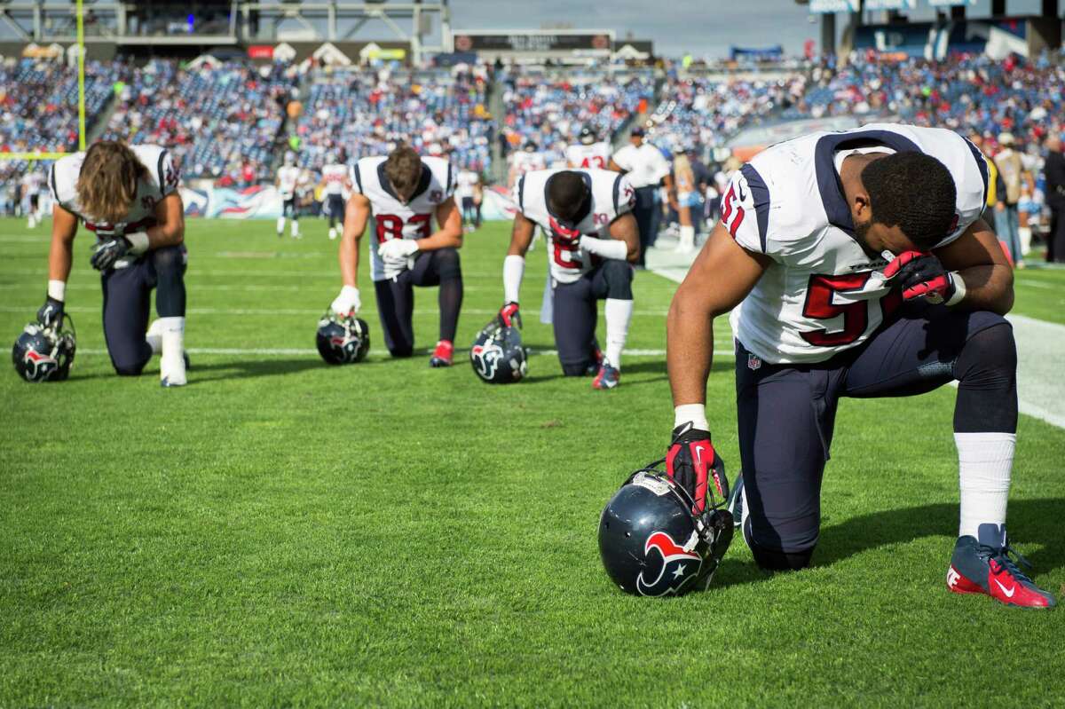 Before any Sunday's mayhem on the field, many NFL players - like Texans inside linebacker Darryl Sharpton (51) and three teammates - take a moment for prayer.