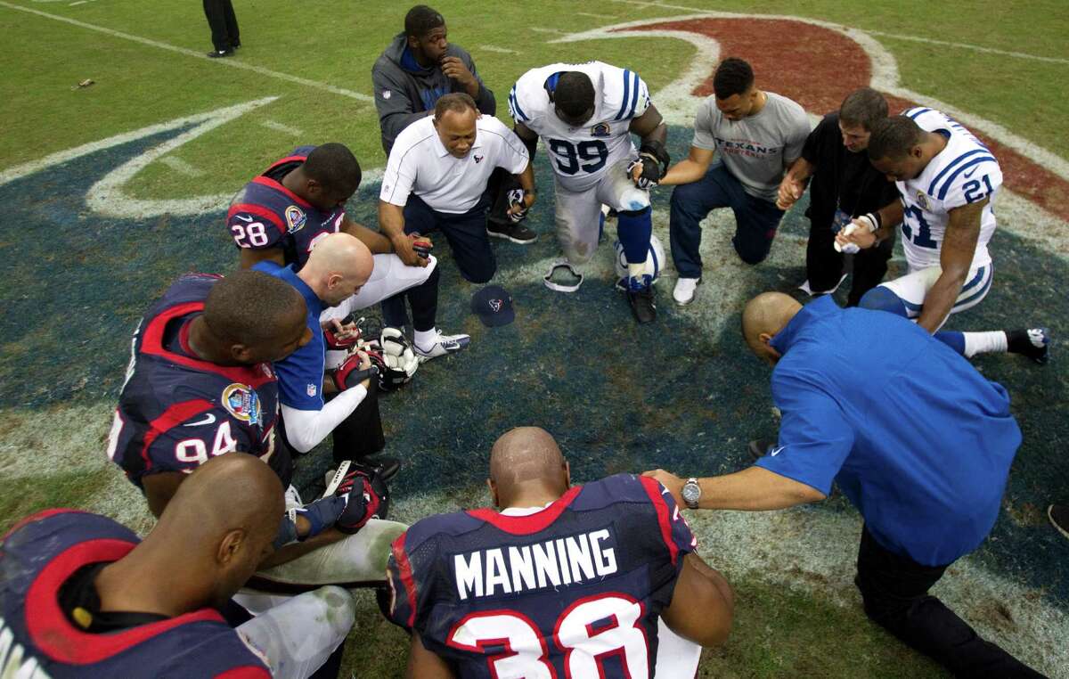 Players from both teams kneel in prayer together on Dec. 16 at Reliant Stadium after a game between Houston and the Indianapolis Colts.