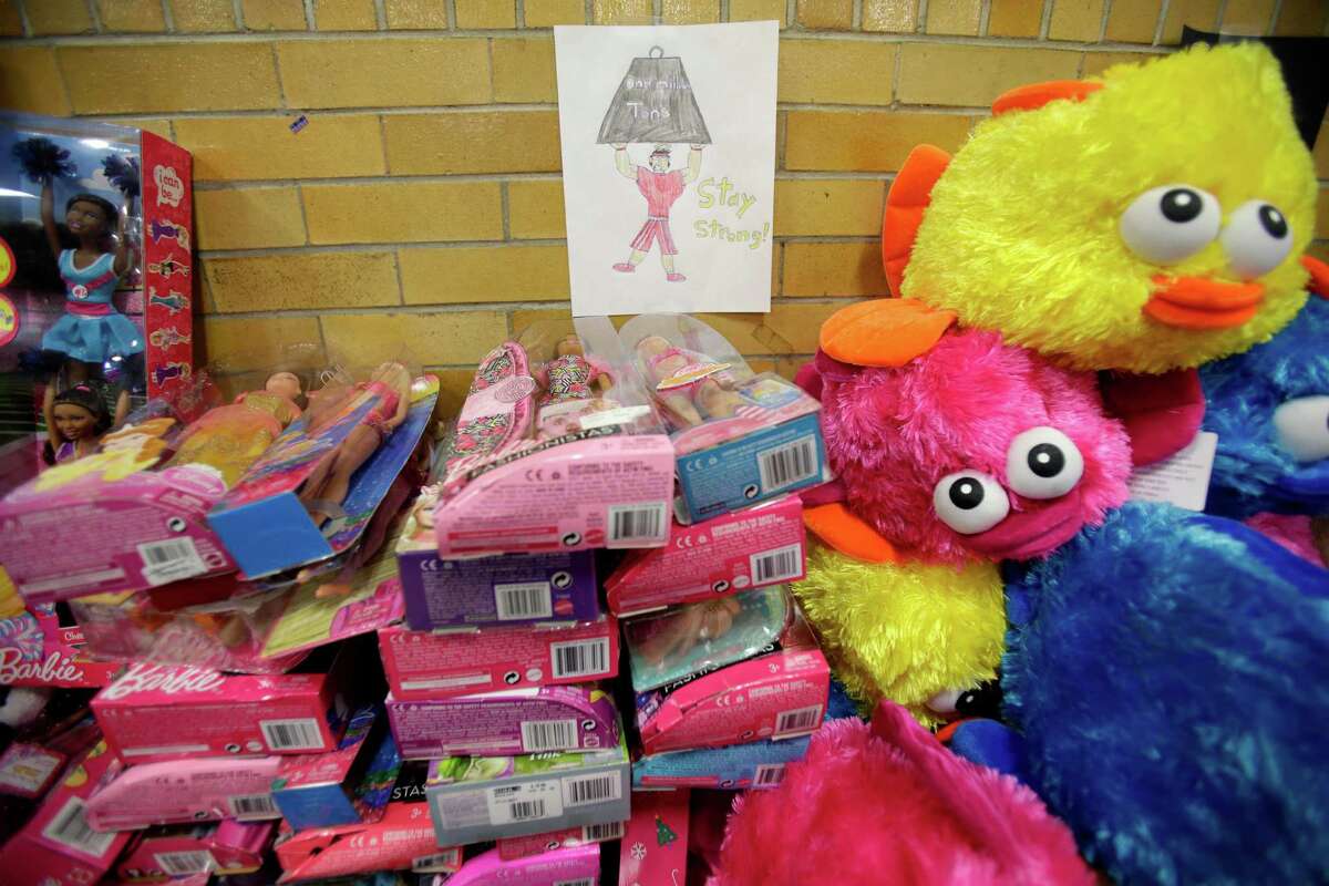 A message of support hangs over a table full of donated toys at the town hall in Newtown, Conn., Friday, Dec. 21, 2012. (AP Photo/Seth Wenig)